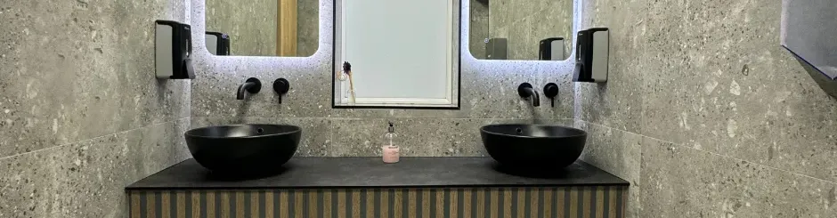 Two black modern sinks side by side